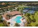 Aerial view of the community pool, hot tub, club house, and pickleball courts at 7140 Marsh View Ter, Bradenton, FL 34212