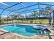 Inviting screened-in pool and spa area surrounded by mature trees at 7140 Marsh View Ter, Bradenton, FL 34212