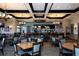 Elegant restaurant boasts tables, chairs, lighting fixtures, and a full bar for a comfortable and upscale dining experience at 7140 Marsh View Ter, Bradenton, FL 34212