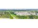 Scenic aerial view of a residential area with tree-lined streets and neatly arranged homes with city skyline at 743 Stonecrest Dr, Sarasota, FL 34232