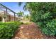 Landscaped backyard with a screen-enclosed lanai, providing a relaxing and private outdoor space at 743 Stonecrest Dr, Sarasota, FL 34232