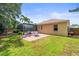 The manicured backyard features a patio area perfect for outdoor dining, adjacent to the screened-in pool at 743 Stonecrest Dr, Sarasota, FL 34232