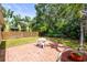 Charming backyard patio with seating offers a great spot for outdoor dining and relaxing in a lush setting at 743 Stonecrest Dr, Sarasota, FL 34232
