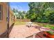 Backyard patio with white table and chairs offers a great space for outdoor dining and entertaining at 743 Stonecrest Dr, Sarasota, FL 34232