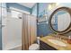 Bathroom featuring blue walls, a shower-tub, a vanity sink, and decor at 743 Stonecrest Dr, Sarasota, FL 34232