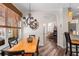 Dining area features a wooden table, decorative chandelier, and an arched doorway to the living room at 743 Stonecrest Dr, Sarasota, FL 34232