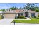 Well-maintained home featuring a manicured front lawn and classic design elements that offer curb appeal at 743 Stonecrest Dr, Sarasota, FL 34232