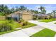 View of the home showcasing a well-manicured lawn, a two-car garage, and a landscaped front yard at 743 Stonecrest Dr, Sarasota, FL 34232