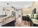 Kitchen has black and white cabinets and granite countertops and an opening looking into the dining room at 743 Stonecrest Dr, Sarasota, FL 34232