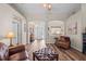 Bright living room with hardwood floors, high ceilings, and arched doorways to the foyer and dining room at 743 Stonecrest Dr, Sarasota, FL 34232