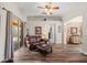 Open-concept living room with wood floors, brick accent wall, and sliding glass doors to the patio at 743 Stonecrest Dr, Sarasota, FL 34232