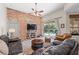 Spacious living room features a brick accent wall, sliding glass door access to the pool, and comfortable seating at 743 Stonecrest Dr, Sarasota, FL 34232