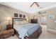 Comfortable main bedroom with wood furniture, ceiling fan, and view to tub and shower at 743 Stonecrest Dr, Sarasota, FL 34232