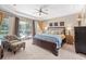 Comfortable main bedroom with a ceiling fan, sliding glass doors, and outdoor views at 743 Stonecrest Dr, Sarasota, FL 34232