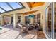 Relaxing covered patio features comfortable seating and a mounted TV, ideal for outdoor entertainment at 743 Stonecrest Dr, Sarasota, FL 34232