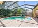 Sparkling pool features a built-in spa and sun shelf, enclosed within a screened lanai for year-round enjoyment at 743 Stonecrest Dr, Sarasota, FL 34232