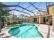 Inviting pool and spa area enclosed with a screened-in lanai, surrounded by lush landscaping for added privacy at 743 Stonecrest Dr, Sarasota, FL 34232