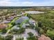 Aerial view of neighborhood featuring homes along a pond and cul-de-sac in lush wooded area at 7513 Coventry Ct, Lakewood Ranch, FL 34202