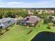 An aerial shot showcases a beautifully landscaped backyard with a pond view and a screened pool at 7513 Coventry Ct, Lakewood Ranch, FL 34202