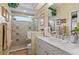 Well-lit bathroom with updated fixtures, shower with glass door, and white cabinetry at 7513 Coventry Ct, Lakewood Ranch, FL 34202