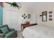 Bedroom with white walls, closet, and green accent chair at 7513 Coventry Ct, Lakewood Ranch, FL 34202