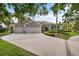 Beautiful single-story home with a well-manicured lawn and a three-car garage at 7513 Coventry Ct, Lakewood Ranch, FL 34202