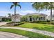 Landscaped front yard featuring a well-maintained lawn and manicured hedges surrounding this charming home at 7513 Coventry Ct, Lakewood Ranch, FL 34202