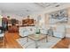 Spacious living room seamlessly connected to the kitchen, featuring hardwood floors, a tray ceiling, and elegant decor at 7513 Coventry Ct, Lakewood Ranch, FL 34202