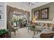 Elegant living room with large windows viewing the pool, and comfortable seating arrangements and stylish decor at 7513 Coventry Ct, Lakewood Ranch, FL 34202