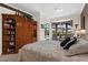 Comfortable main bedroom with an armoire and sitting area overlooking the screened pool at 7513 Coventry Ct, Lakewood Ranch, FL 34202