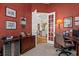 Office with dark wood desk, wine cooler and French doors leading to the living room at 7513 Coventry Ct, Lakewood Ranch, FL 34202