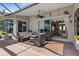 Inviting covered patio with comfortable seating, ceiling fan, and sliding glass doors leading to the interior at 7513 Coventry Ct, Lakewood Ranch, FL 34202