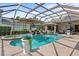 A spacious screened pool area with in-ground pool and hot tub and plenty of room for seating at 7513 Coventry Ct, Lakewood Ranch, FL 34202
