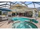 A screened in pool and hot tub with outdoor seating, perfect for relaxation and entertainment at 7513 Coventry Ct, Lakewood Ranch, FL 34202
