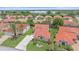 Beautiful aerial view of a single-Gathering home with a tile roof, landscaped lawn, and a paved driveway at 8382 Creekview Ln, Englewood, FL 34224