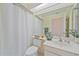Well-lit bathroom with a shower curtain, ample counter space, and a neutral color scheme at 8382 Creekview Ln, Englewood, FL 34224