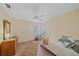 Comfortable bedroom with hardwood floors, a ceiling fan, and natural light from the window at 8382 Creekview Ln, Englewood, FL 34224