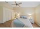 Comfortable bedroom with ceiling fan, ensuite, and stylish coastal decor at 8382 Creekview Ln, Englewood, FL 34224