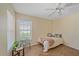 Inviting bedroom featuring wood floors, a ceiling fan, and a cozy window nook at 8382 Creekview Ln, Englewood, FL 34224