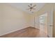 Spacious bedroom featuring wood-look floors, neutral walls, and a large window with shutter blinds at 8382 Creekview Ln, Englewood, FL 34224
