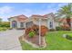 Attractive home exterior with a well-manicured lawn and landscape lighting at 8382 Creekview Ln, Englewood, FL 34224