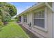 Charming home exterior with a lush lawn, garden beds, and beautiful windows at 8382 Creekview Ln, Englewood, FL 34224