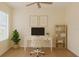 Bright office featuring modern desk setup, bookshelf, natural light, and wood-look flooring at 8382 Creekview Ln, Englewood, FL 34224