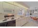 Clean kitchen featuring white appliances, tile backsplash, and a bright, airy ambiance at 8382 Creekview Ln, Englewood, FL 34224