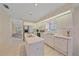 Well-equipped kitchen with white cabinetry, tile flooring, and stainless-steel appliances at 8382 Creekview Ln, Englewood, FL 34224