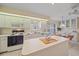 Well-lit kitchen boasts modern appliances, white cabinetry, and a convenient island for meal preparation and casual dining at 8382 Creekview Ln, Englewood, FL 34224