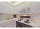 Functional kitchen featuring white appliances, ample counter space, and updated cabinetry at 8382 Creekview Ln, Englewood, FL 34224