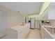 Spacious kitchen with white cabinetry, a tile floor, and ample counter space at 8382 Creekview Ln, Englewood, FL 34224