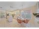 The kitchen features white appliances and tile floors, complemented by a cheerful breakfast nook and ceiling fan at 8382 Creekview Ln, Englewood, FL 34224