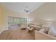 Bright living room featuring wood floors, neutral tones, and a ceiling fan at 8382 Creekview Ln, Englewood, FL 34224